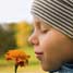 Boy smelling flower