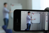 A student teaching chemistry, seen through a camcorder lense