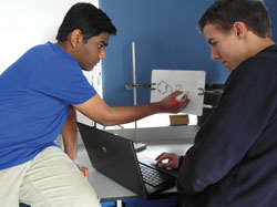 A student draws a reaction mechanism in front of a webcam