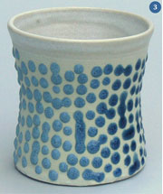 White cup with blue raised spots