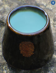 Cup with iron oxide glaze. Brown on the outside, light blue inside