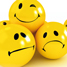 Yellow pills with smiley and unhappy faces