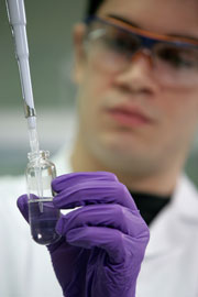 Scientist pipetting a liquid