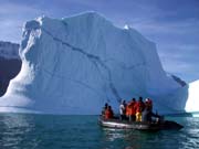 Photo of a large ice berg with a boat in front