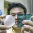 Ho Bum Park holding two samples of the chlorine-tolerant, desalination membrane