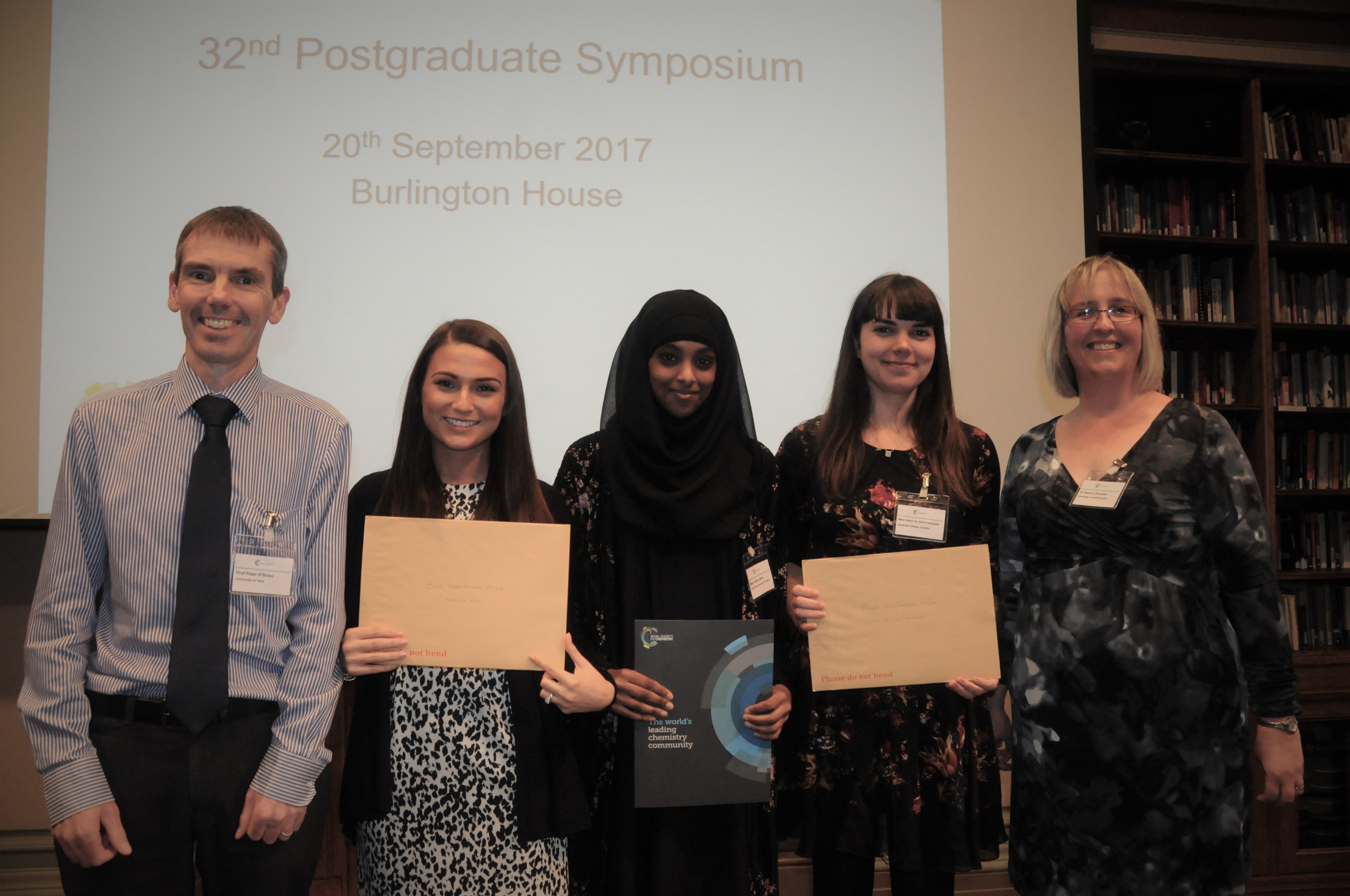 The three prize winners - Jessica Hill (University of Bristol), Fahima Idiris (Queen Mary University of London) and Sahra St John-Campbell (Imperial College London), flanked by the current Chair (Professor Peter O’Brien) and Secretary (Dr Sharon Rossiter).