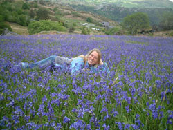 Vera Thoss lying in bluebell field
