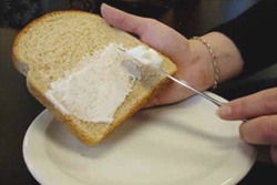 Spreading margarine on toast