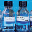 Two glass bottles containing colourless chemicals