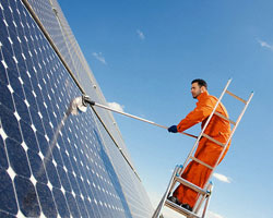 Man cleaning solar panels