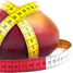 A mango with a tape measure around it