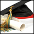 mortarboard on a pile of textbooks