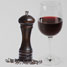 A peppermill and a glass of red wine