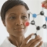 Teacher holding up molecule model