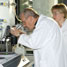 Scientists using a microscope