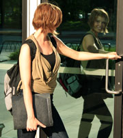 Young female opening university door