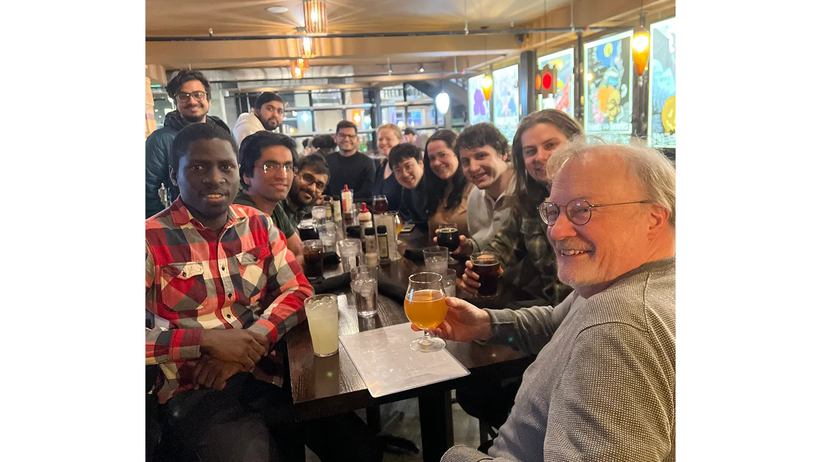 Professor James McCusker with a group of people sitting around a table