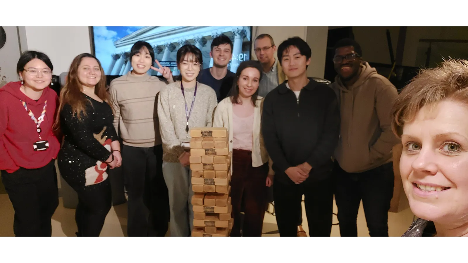 Zoe with colleagues playing wooden jenga