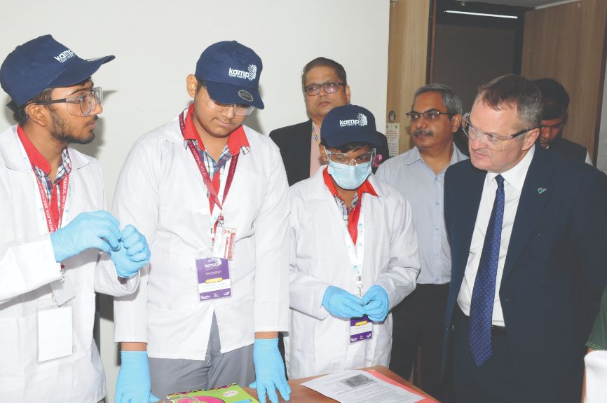 Dr Paul Lewis (right) speaks with researchers in India Dr Paul Lewis (right) speaks with researchers in India