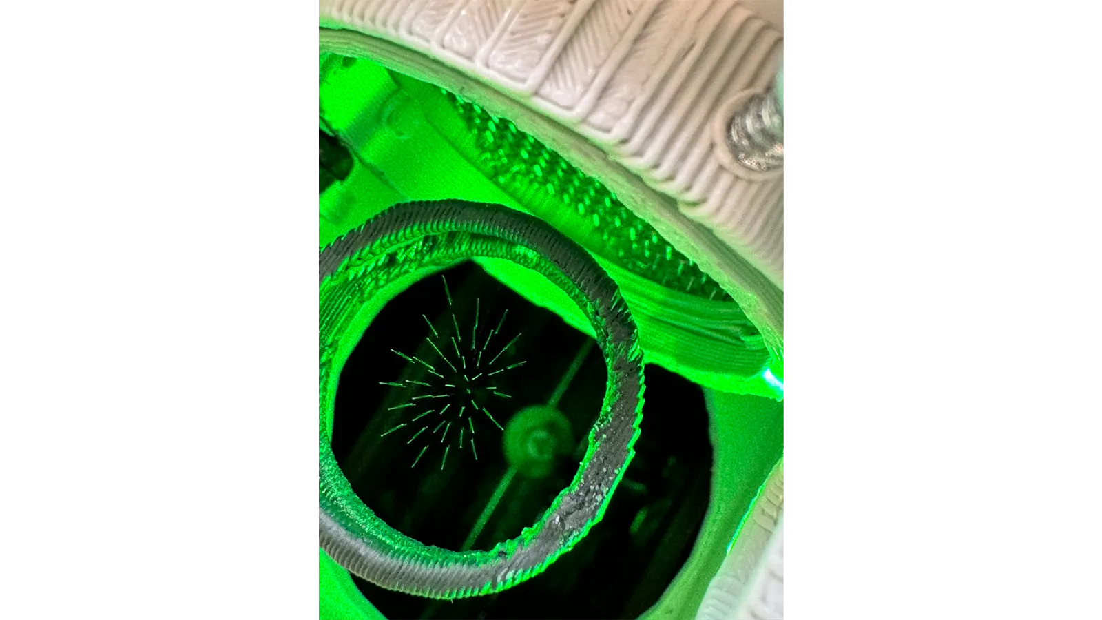 a green light coming out of a machine