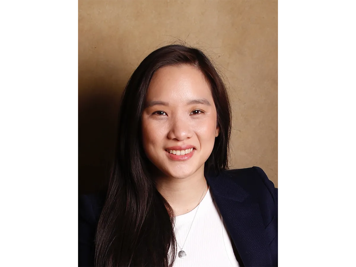 Dr Florence Huynh in a suit, smiling