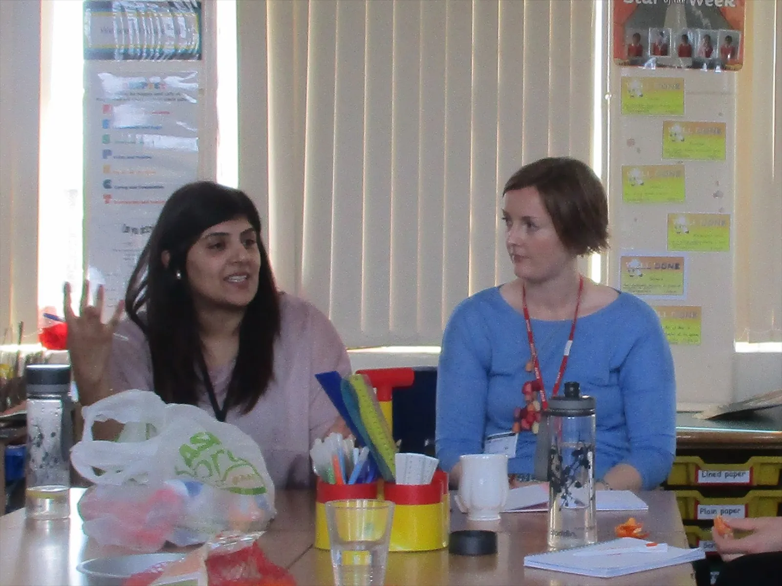 Teachers discussing primary science teaching in a classroom