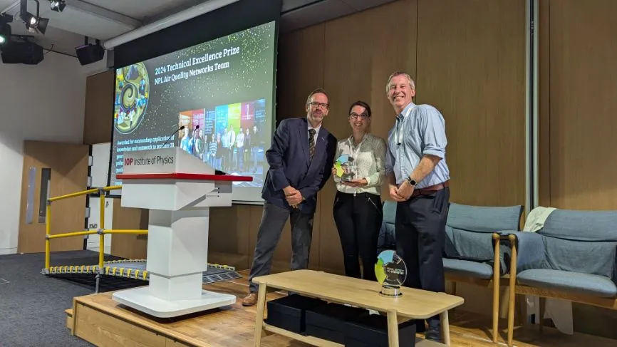 Two members of the NPL Air Quality Team take their RSC Technical Excellence Prize, with RSC Head of Professional Standards Toby Underwood to the left