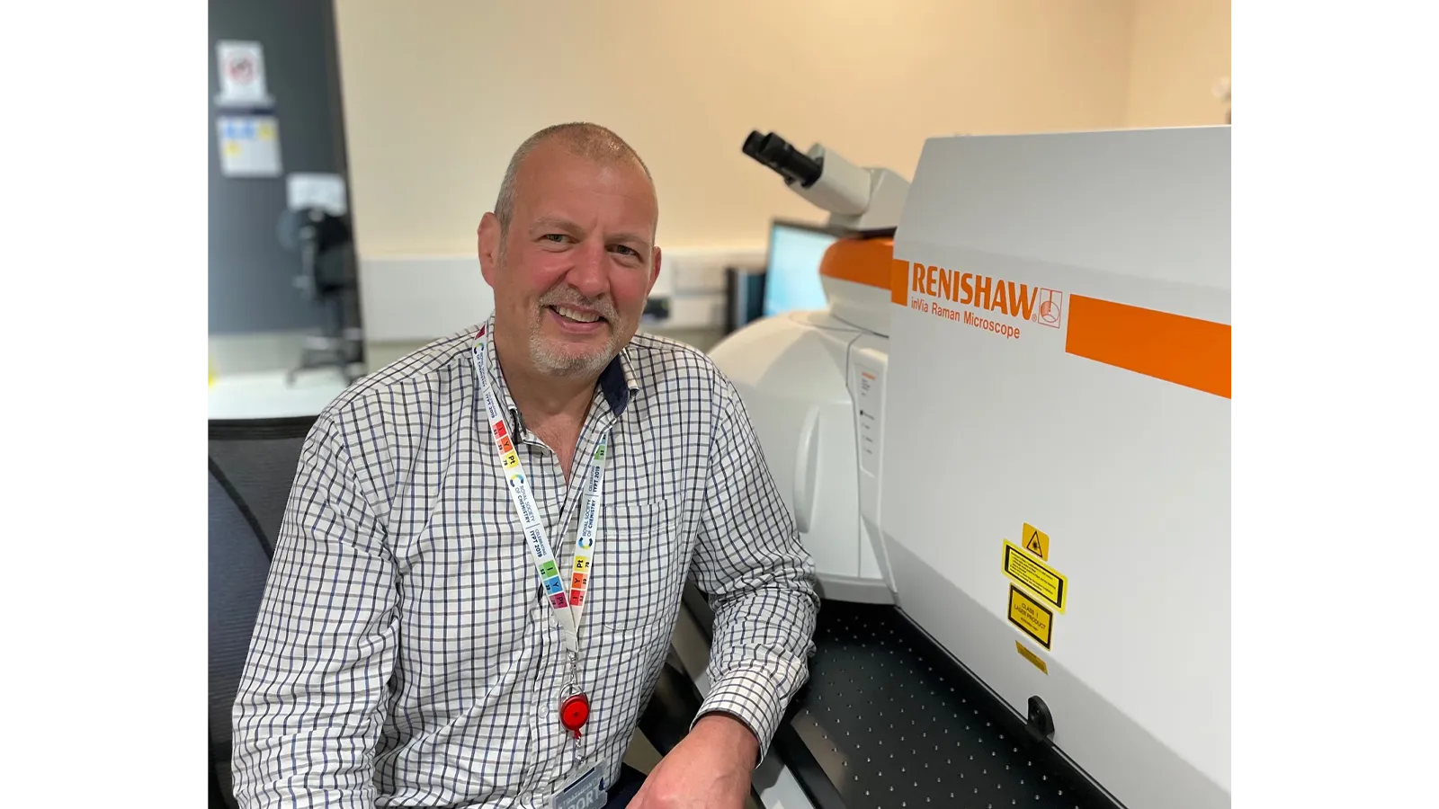 Professor Duncan Graham next to machinery in his lab