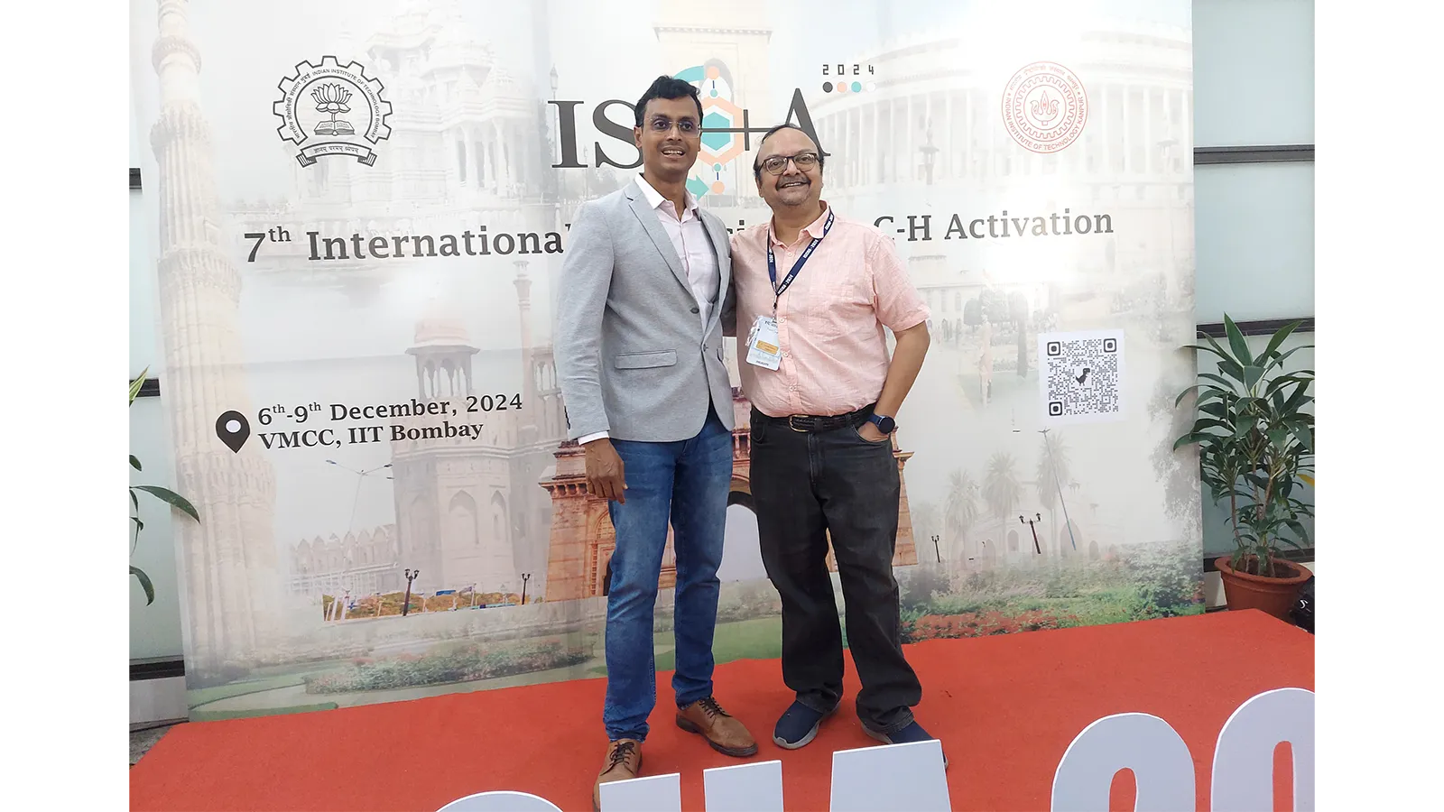 Two of AEEon Collective team posing for photos at an event